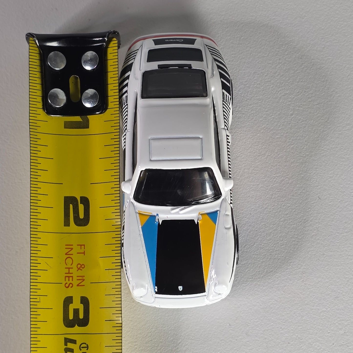 Hot Wheels 96 Porsche Carrera Die-Cast Car Model 1:64 Scale White/Blue/Yellow With Blue Rims Toy